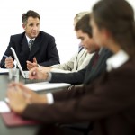 Businessman Conducting a Meeting with His Staff